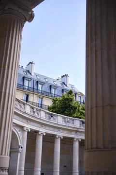 Classical columns and Parisian architecture with rooftop greenery Stock Photos