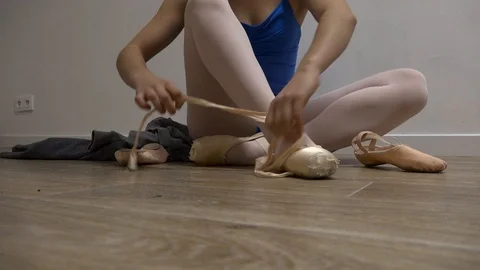 Classical dancer putting her shoe Stock Footage 85638680