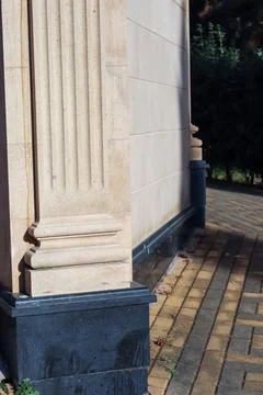 Classical fluted column in light stone adjacent to modern wall and patterne.. 写真素材