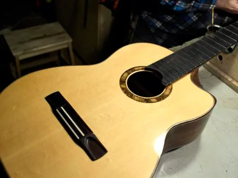 The classical guitar case is on the table at the guitar Luthiers. Stock Photos