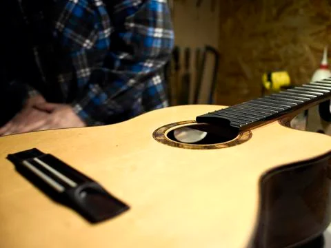The classical guitar case is on the table at the guitar Luthiers. Stock Photos
