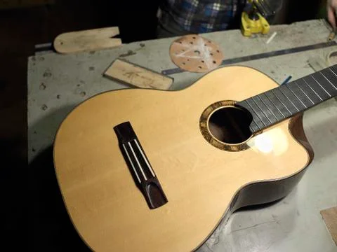 The classical guitar case is on the table at the guitar Luthiers. Stock Photos