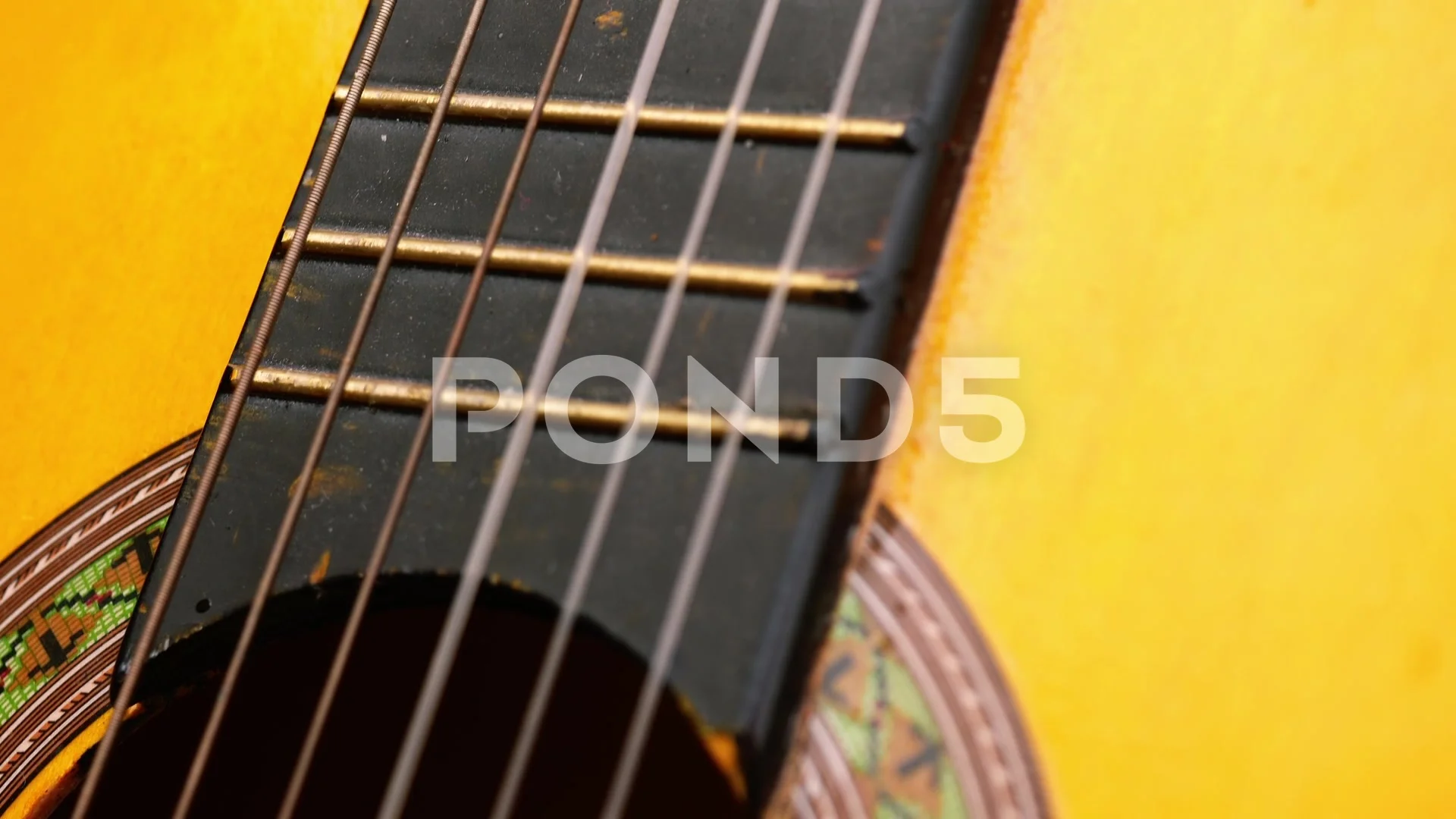 Classical guitar strings and frets close up