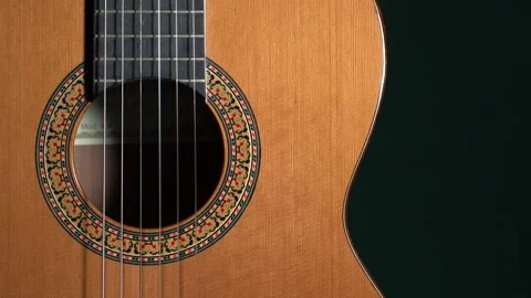 Classical guitar turning on dark background Stock Footage 133227951