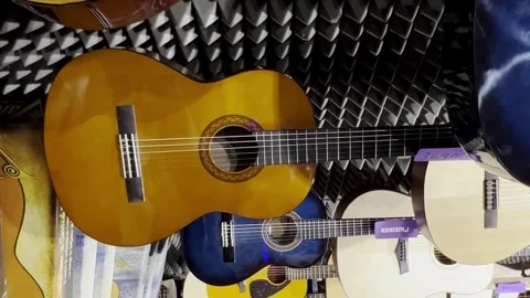 Classical guitars in a musical instrument store. Many musical instruments Stock Footage 250030268