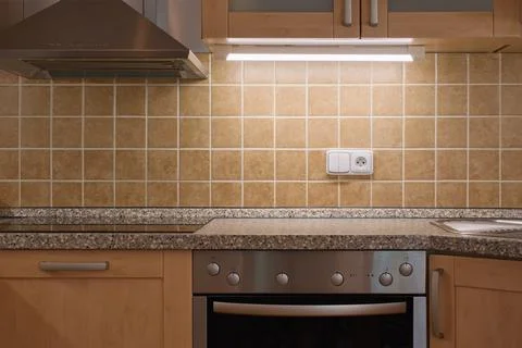 Classical kitchen interior. Brown tiles, oven and kitchen extractor fan. Фото