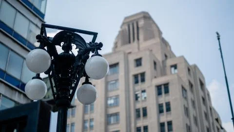 Classical Lamppost With a Tall Building in the Background Fotos de archivo