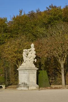 Classical marble statue in Versailles garden with autumn trees Stock Photos