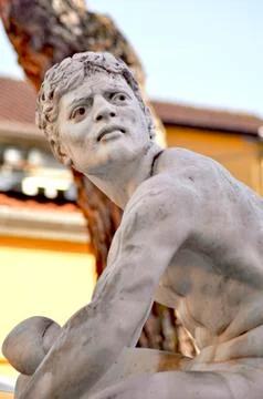A classical marble statue of a young man. Stock Photos