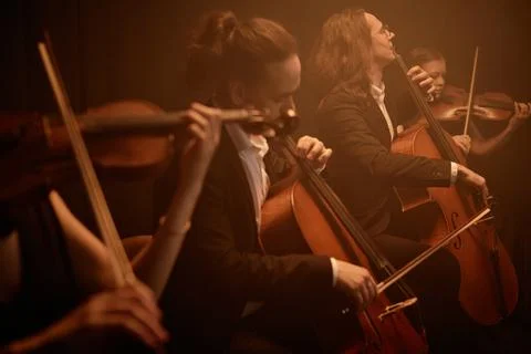 Classical Music Artists Playing String Instruments during Concert Stock Photos