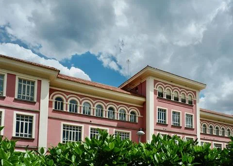 Classical old-fashioned house with rounded windows and bright pink facade s.. Stock Photos