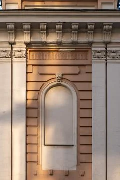 Classical Ornate Building Facade With Arched Niche and Decorative Cornice in  Stock Photos
