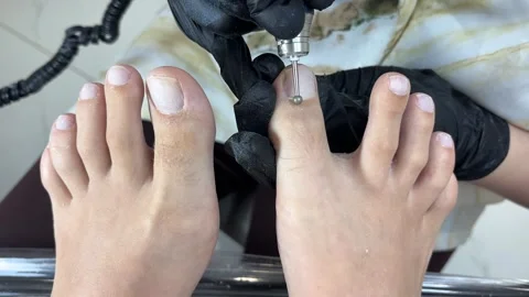 Classical pedicure in a spa salon, cutting off cuticle nails of feet. Hardware Stock Footage 316117979