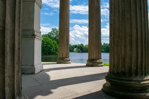 Classical Pillars Framing Scenic Summer Lake View Stock Photos