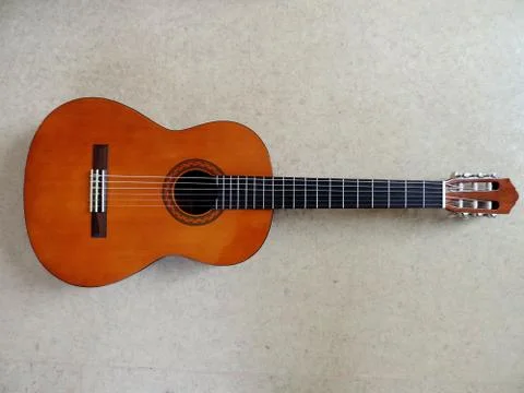 Classical six-string Acoustic Guitar on gray background. Foto stock