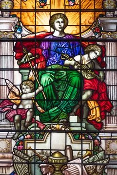 Classical stained glass window with a central figure and cherubs. London, UK, 16 Stock Photos