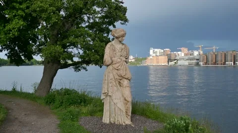 Classical statue by Djurgården waterfront under stormy Stockholm sky Stock Footage 320744386
