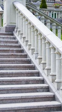 Classical stone staircase leads into lush green park environment Stock Photos