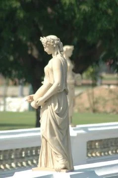 A classical white statue in a garden. Stock Photos
