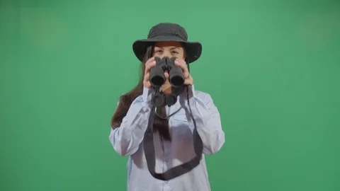 Classical woman explorer chasing something in the frame with binoculars studio Stock Footage 117975856