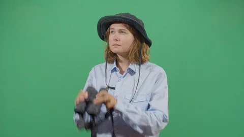 Classical woman explorer chasing something in the frame with binoculars studio Stock Footage 117979286