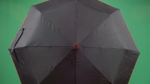 Classical woman explorer opens an umbrella to reveal face studio isolated shot Stock Footage 117975729
