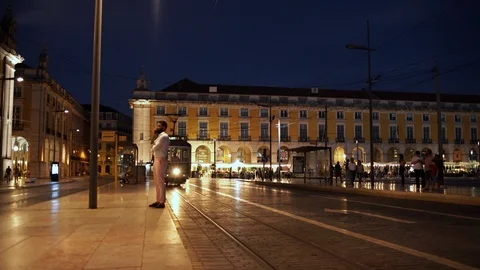 Classical yellow tram passing by commerce square (Para do commercio) at night in Stock Footage 89541910