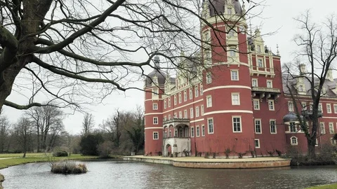 Classicist castle with yellow, red facade and water moat Stock Footage 91581671
