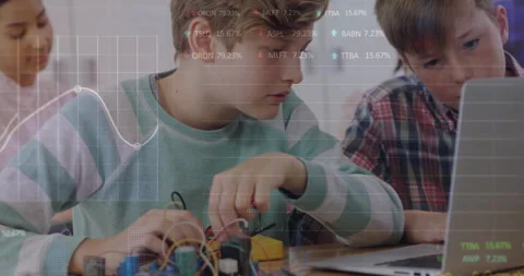 Classmates connecting wires at tech class table, typing commands, monitoring Stock Footage 312298110