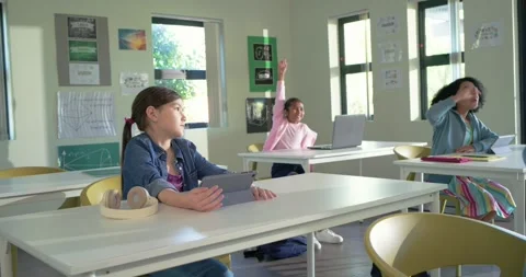 Classmates following peer hand raise, front-left teen raising hand answering Stock Footage 340257157