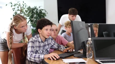 Classmates solve computer problem together in a school computer class Stockbeeldmateriaal 274114160