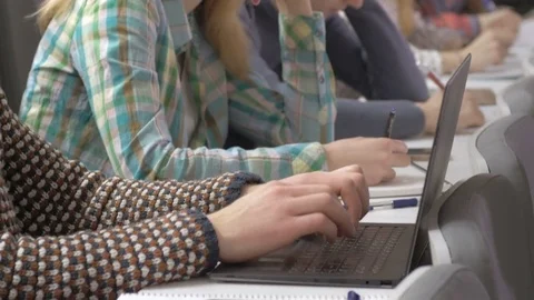 Classmates studying while listening to a speaker in a university lecture Stock Footage 69912281