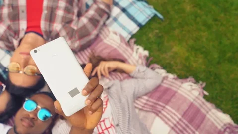 Classmates taking selfie laying on a grass. Stock Footage 127294773