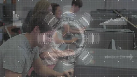 Classmates typing at computers in tech lab, overlay fading in animating HUD code Stock Footage 310429980