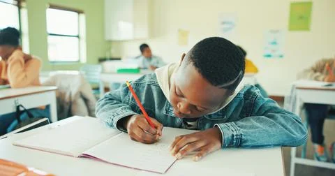 Classroom, child and writing notes in book for learning, maths lesson and p.. Stock Photos
