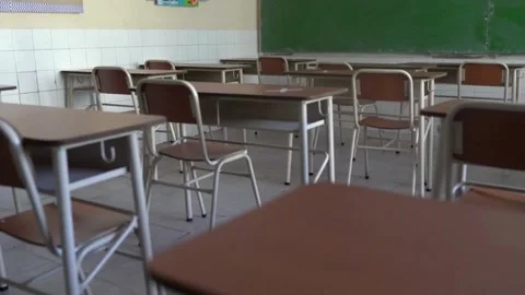 Classroom with desks and chairs. Interior of school room with chalkboard Pan Stock Footage 256720162