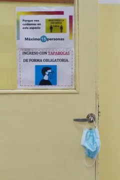 Classroom door informing the protocol, use of face mask, distancing. Stock Photos