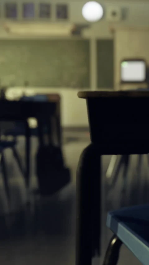 Classroom interior with empty desks and a vintage television in the background Stock Footage 334174268