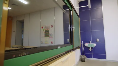 Classroom interior shows tiled wall and sink with towel Stock Footage 333210228