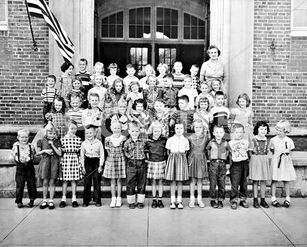 Classroom of kids and a teacher in front of building Stock Photos