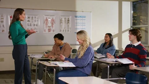 Classroom scene with a teacher engaging students in an interactive discussion as Stock Footage 319170217