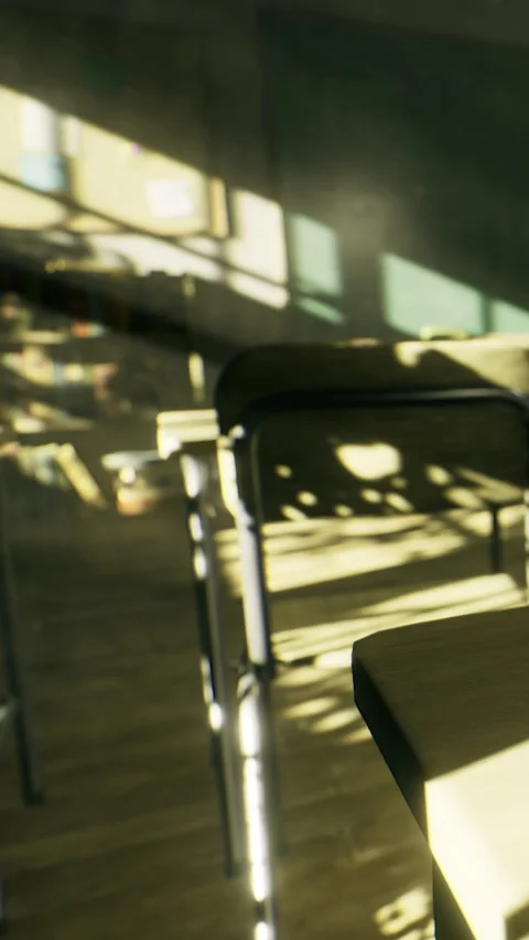 Classroom setting with empty desks and sunlight in a quiet environment Stock Footage 334247812