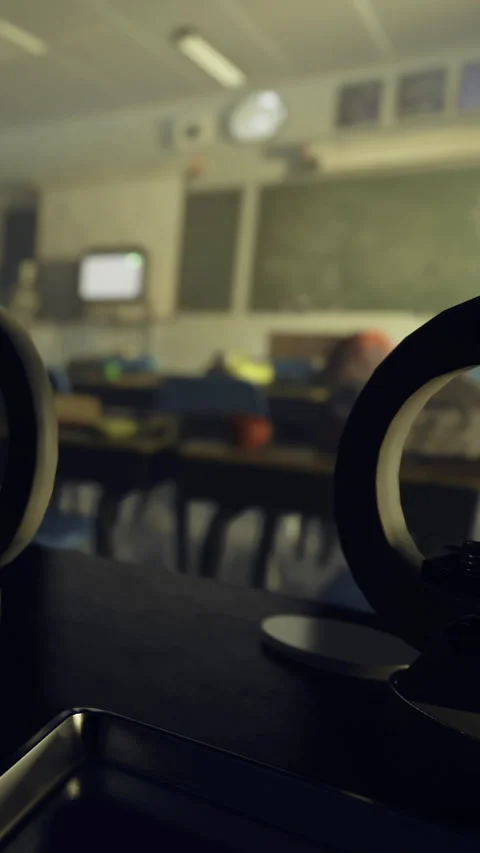 Classroom setting with objects on table and chalkboard in background Stock Footage 330450002