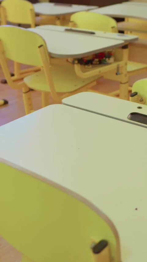 The classroom is spacious and contemporary, featuring bright yellow desks and Stock Footage 279218231