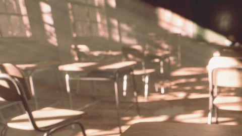 Classroom with sunlight shining through windows and empty chairs Stock Footage 344059920