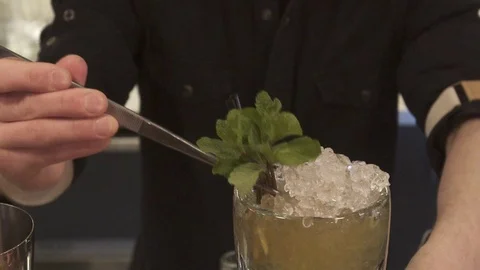 Classy bartender barman serves plain classic rum based drink cocktail lime Stock Footage 73984180