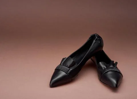 Classy black pointed-toe leather ballet flats with wrinkled and ruffle deta.. Stock Photos
