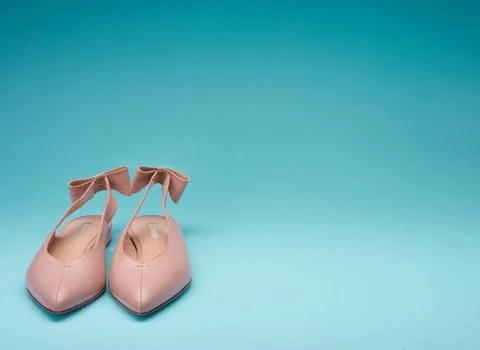 Classy pointed-toe open-back shoes decorated with bows on the back straps, .. Stock Photos