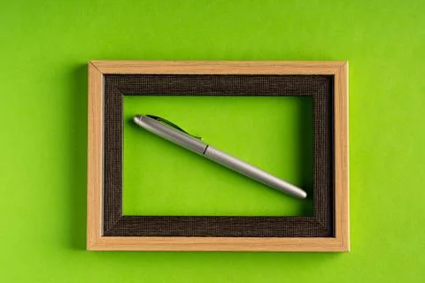 Classy silver pen and empty frame Stock Photos
