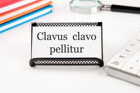 Clavus clavo pellitur. The ancient Greek expression translates as, A wedge .. Stock Photos